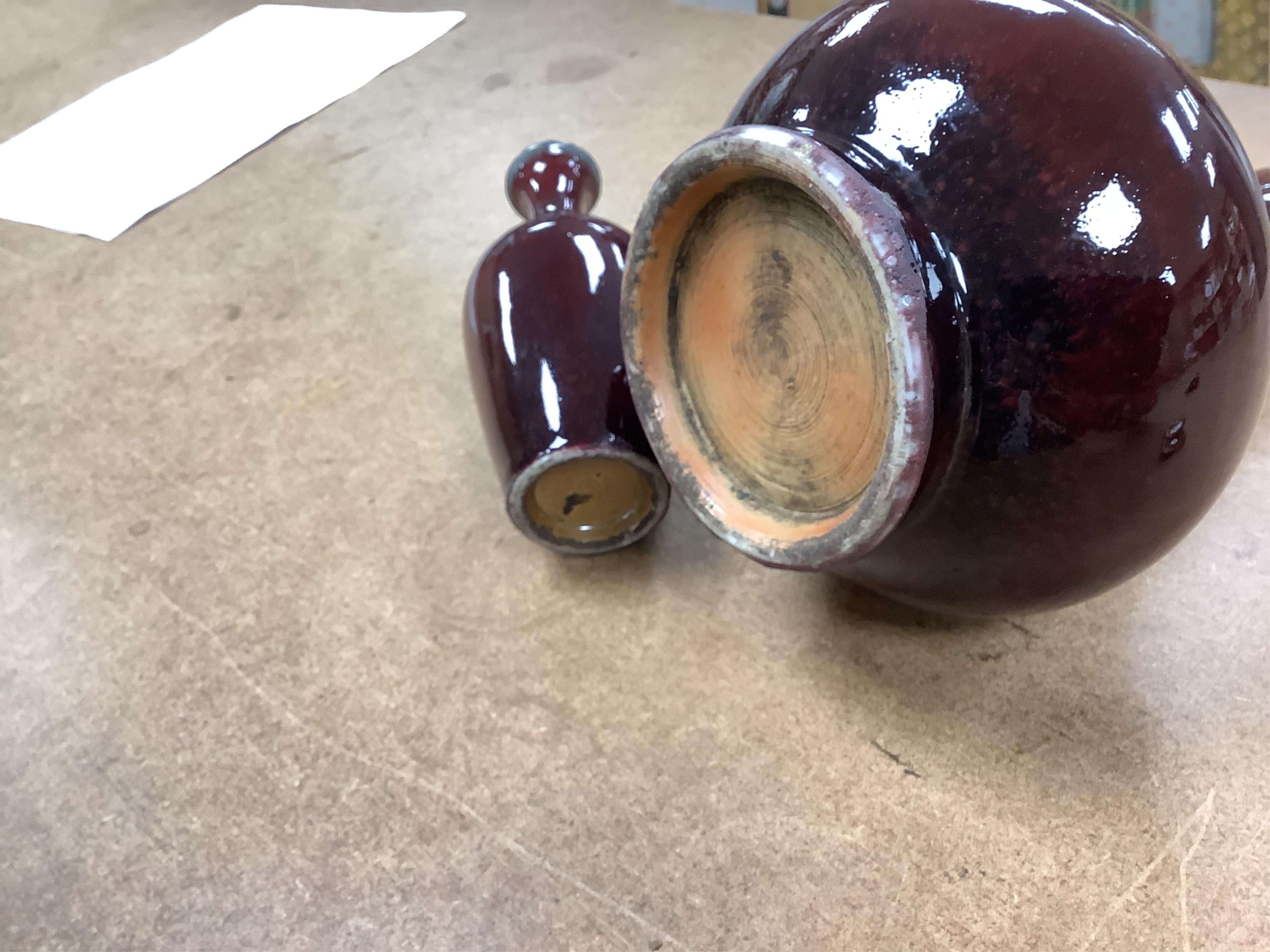 Two Chinese Sang de Boeuf glazed vases to include a bottle neck example, largest 27cm high